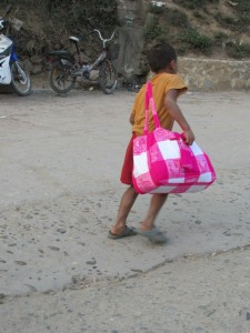 Kid earning his candy money in Pakbeng